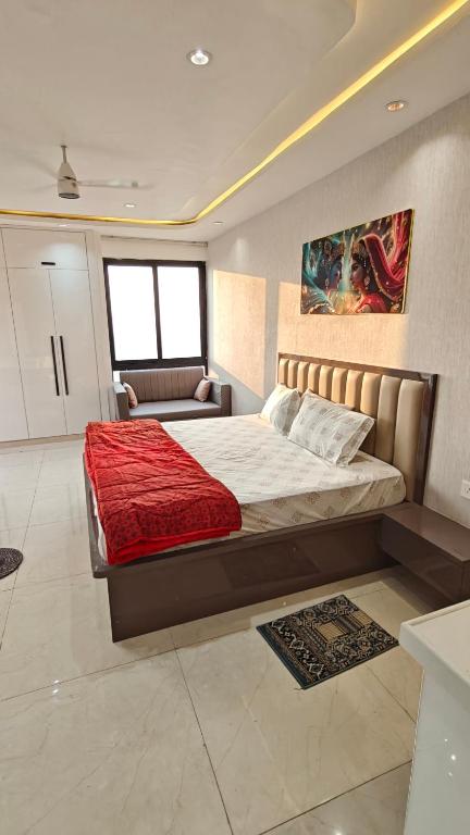 a bedroom with a large bed and a couch at Anandam in Vrindāvan