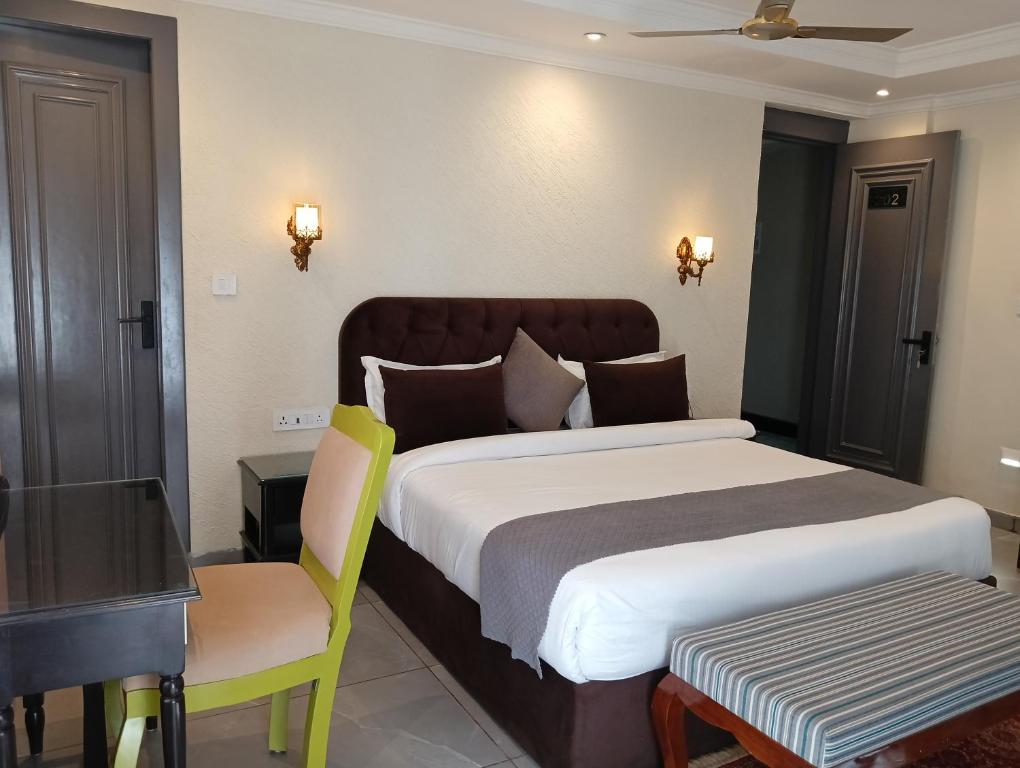 a bedroom with a bed and a desk and a chair at Maheshwari international in Lansdowne