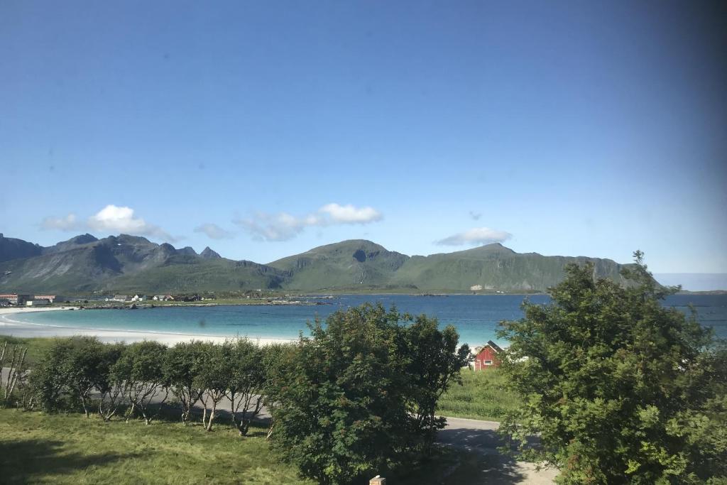 a view of a lake with mountains in the background at House by Ramberg Beach in Ramberg