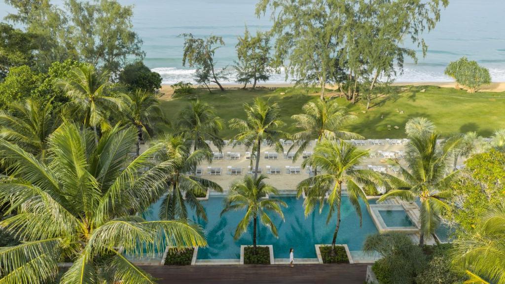 an aerial view of a resort with palm trees and the ocean at Anantara Mai Khao Phuket Villas in Mai Khao Beach