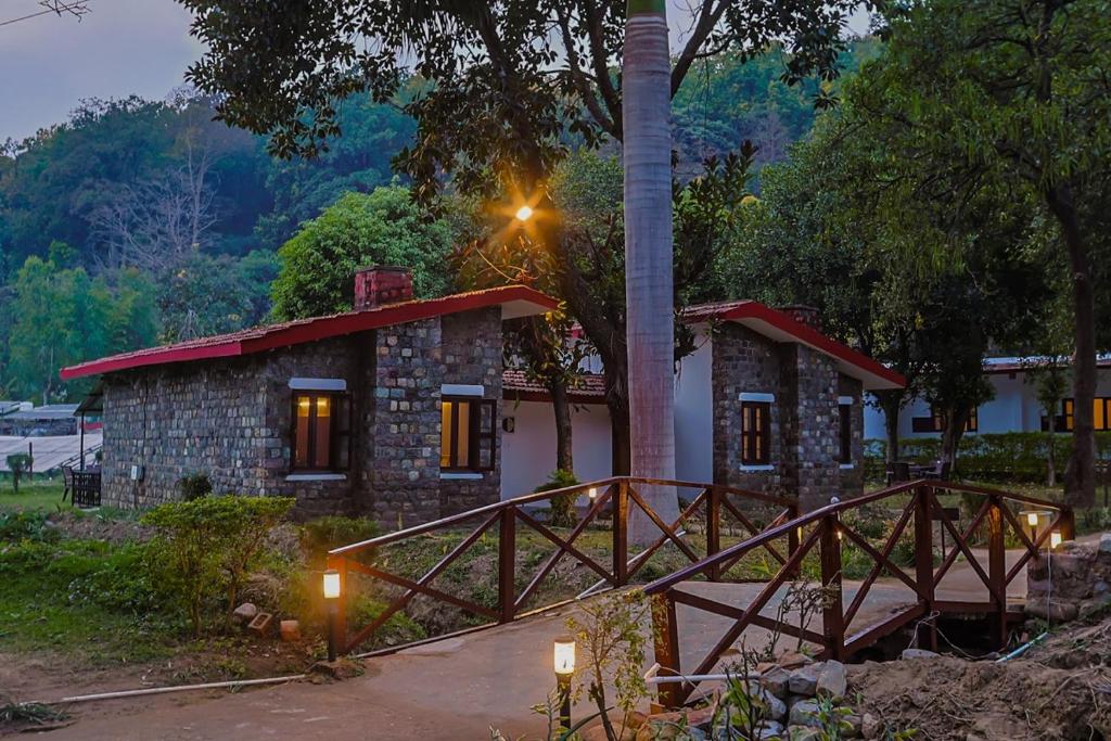 a small house with a pole in front of it at Tripp Jim Corbett A River Access Resort in Marchula