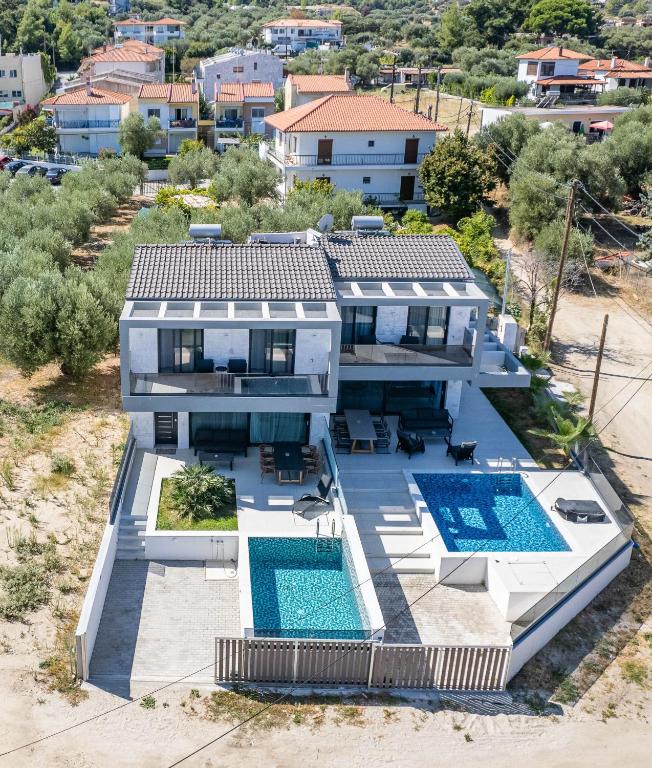 an aerial view of a house with two swimming pools at LUKA VILLAS Plage in Polychrono