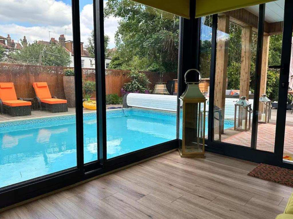 a view of a swimming pool from a house at Chiswick Garden Studio with Outdoor Pool and Boutique Finish in London