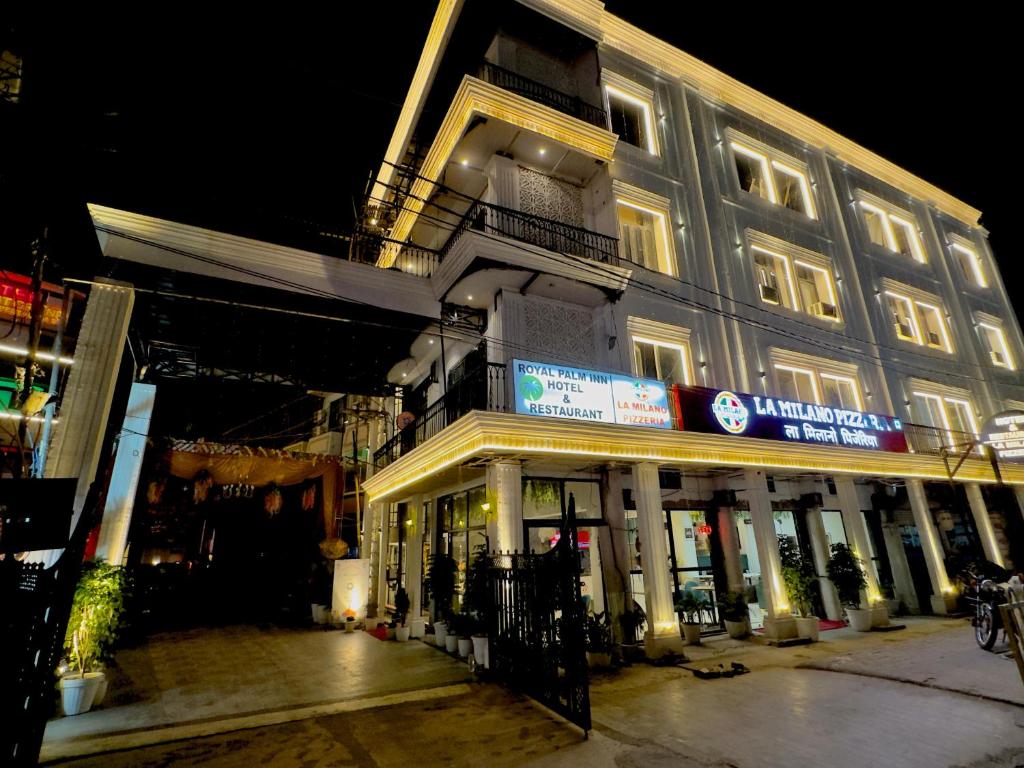 a building with a sign on the side of it at Royal Palm Inn in Jāmb