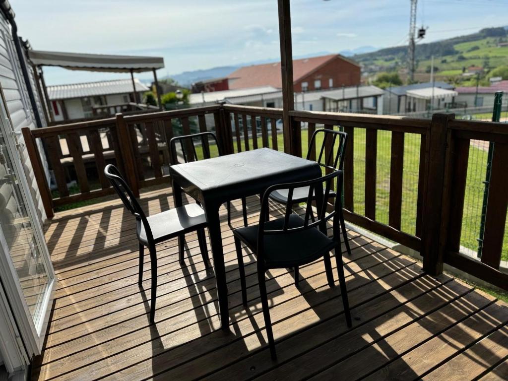 a table and two chairs on a deck at Altamira Camping in Queveda