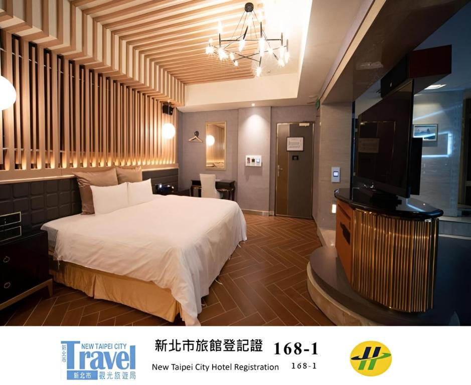 a hotel room with a bed and a flat screen tv at I-more Motel in Yonghe