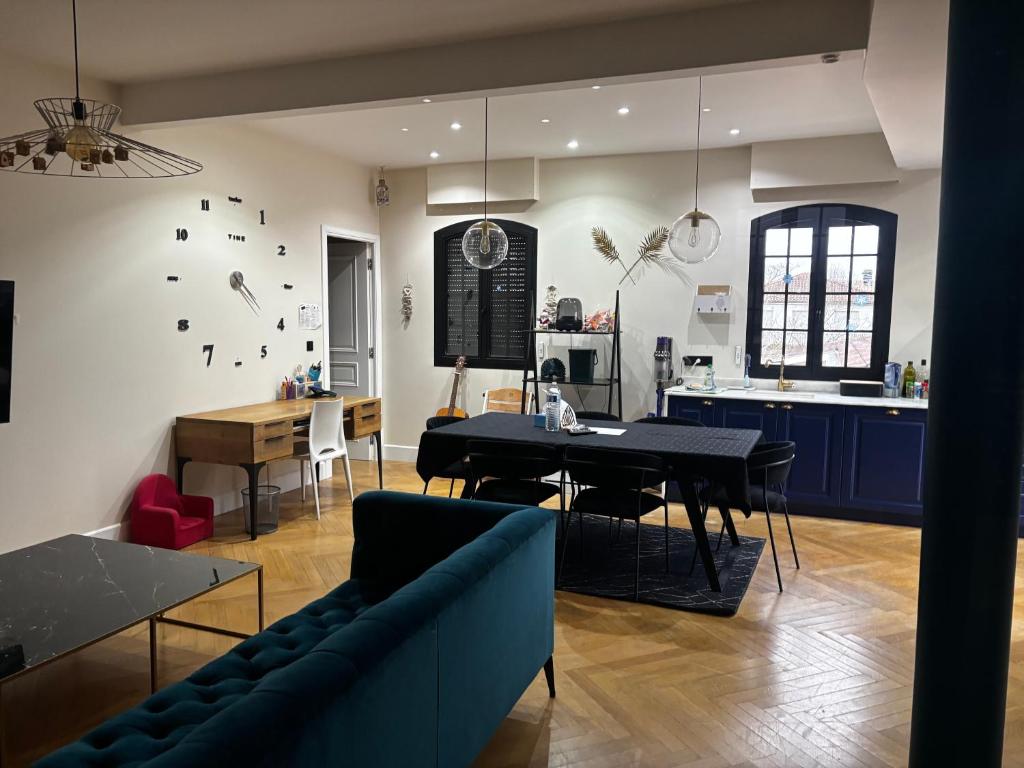 a living room with a blue couch and a table at Apartment with terrace Mérignac in Mérignac