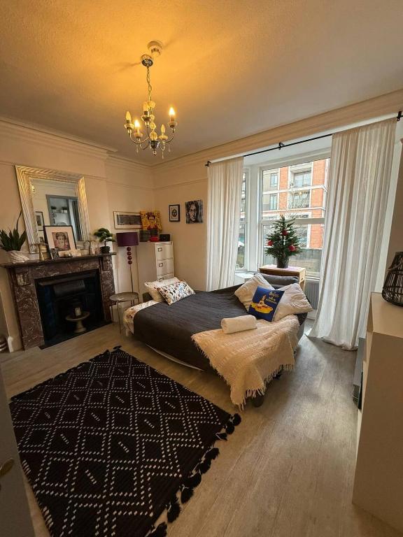 a bedroom with a large bed and a fireplace at Central London Flat 2 bathrooms in London