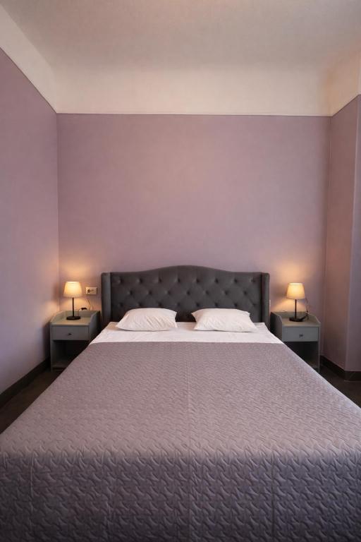 a bedroom with a large bed with two night stands at Viktorija in Riga