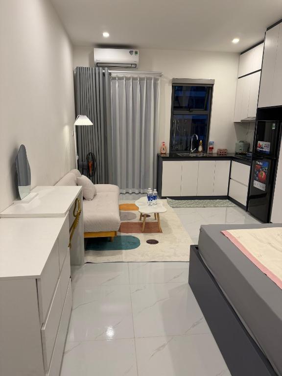 a kitchen and living room with a couch and a table at Mochi Home in An Dương