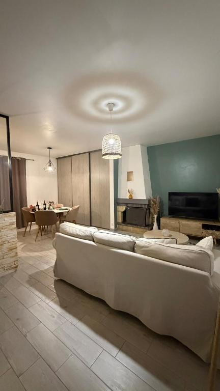 a living room with a couch and a table at Le Green d'Apigné in Le Rheu