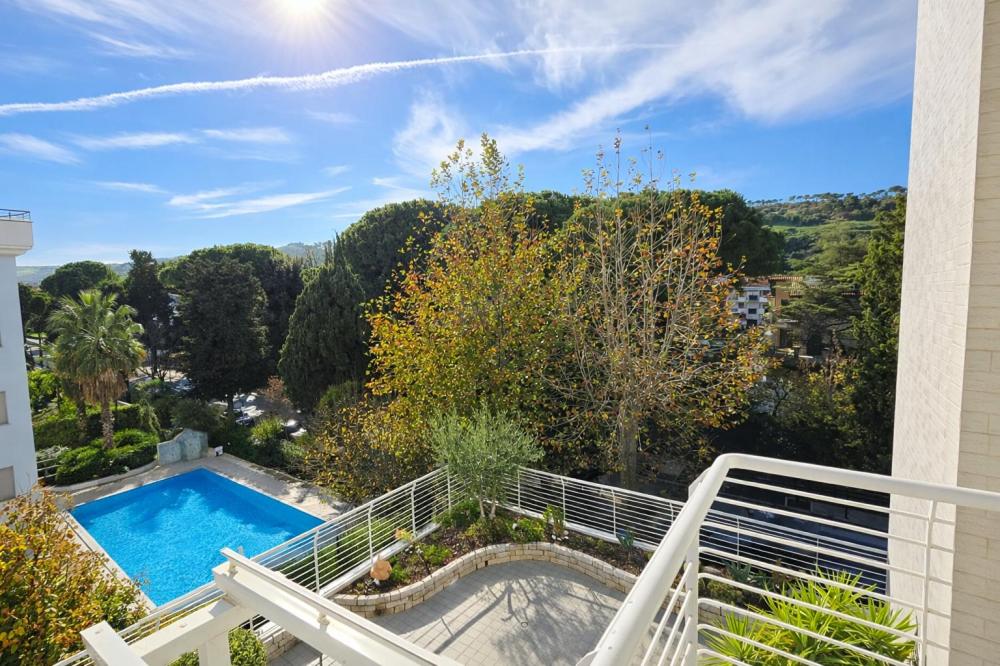 a view of a swimming pool from the balcony of a house at Residence Prestige - Pineto Vacanza in Pineto