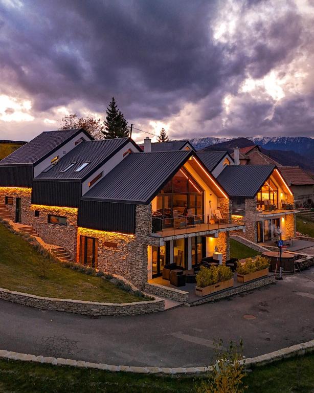 a house with solar panels on top of it at Altfel Bran Chalet 1 in Bran
