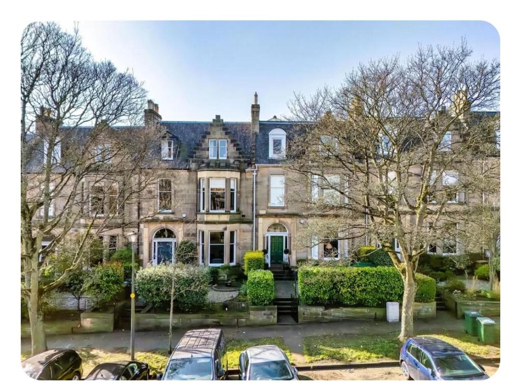 a large house with cars parked in front of it at Murrayfield Gem in Edinburgh