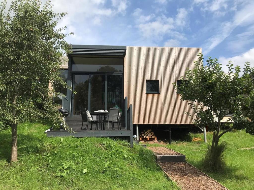 a small house with glass doors and a deck at 2 Bed in Brecon oc-59734 in Talgarth