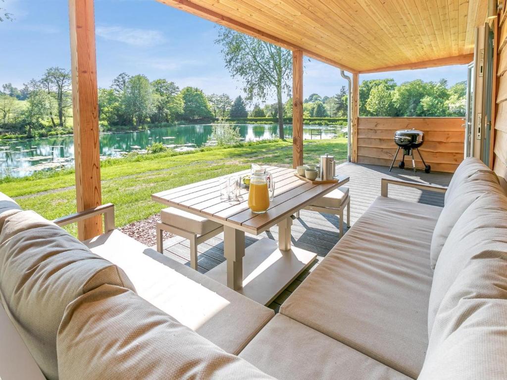 a screened in porch with a couch and a table at 3 Bed in Cullompton oc-96118 in Willand