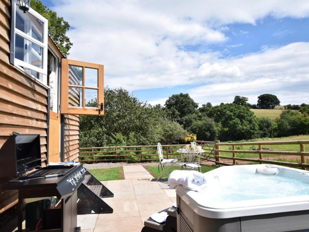 a hot tub on the patio of a house at 1 Bed in Hereford oc-78641 in Callow