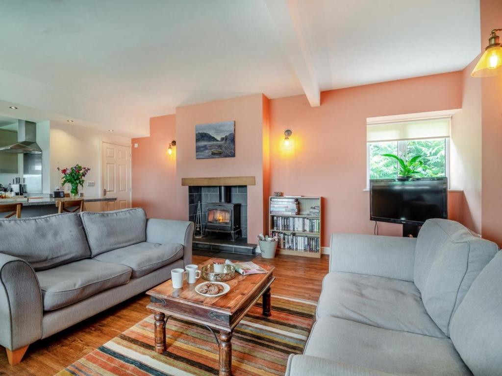 a living room with two couches and a coffee table at 2 Bed in Llangammarch Wells oc-bn059 in Garth