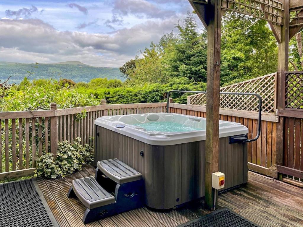 a hot tub on the deck of a house at 1 Bed in Abergavenny oc-52882 in Gilwern