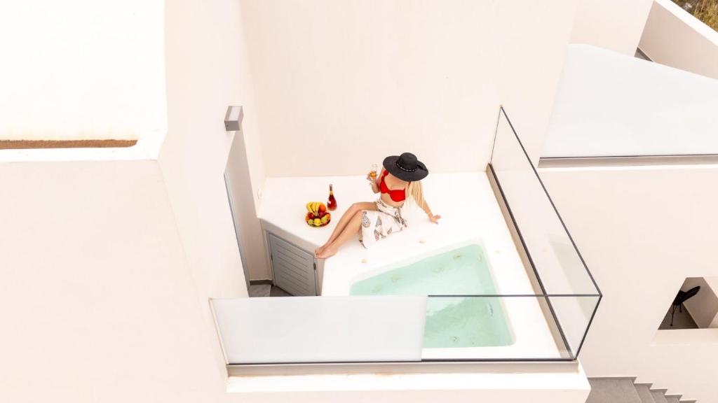 a doll sitting on a dresser in a white room at Stay Lux Suites in Karterados