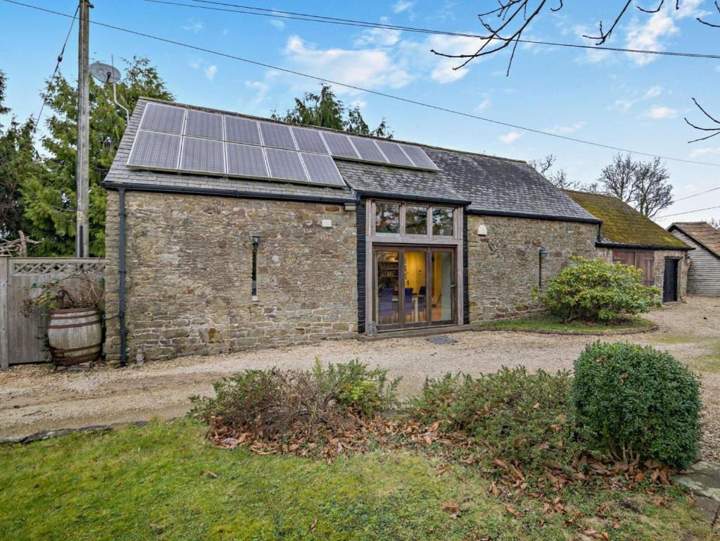 an old brick house with solar panels on it at 2 Bed in Coleford oc-78181 in Symonds Yat
