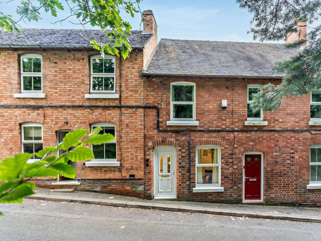 an old brick house with a red door at 2 Bed in Ashbourne oc-85571 in Ashbourne