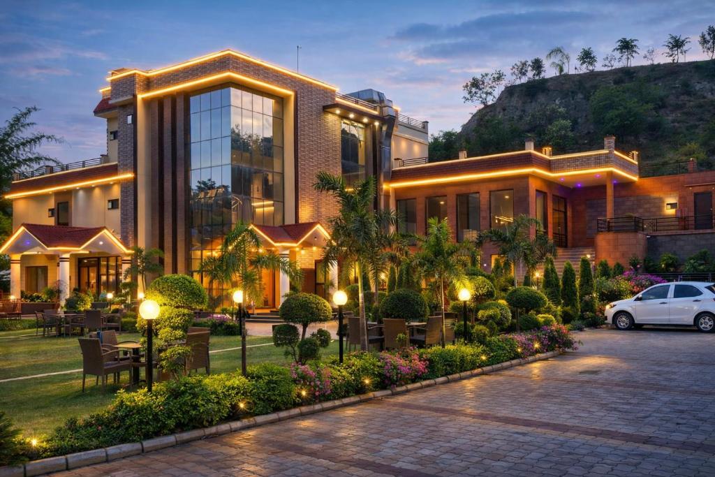 a building with a car parked in front of it at The Asanar Hills in Rūpnagar