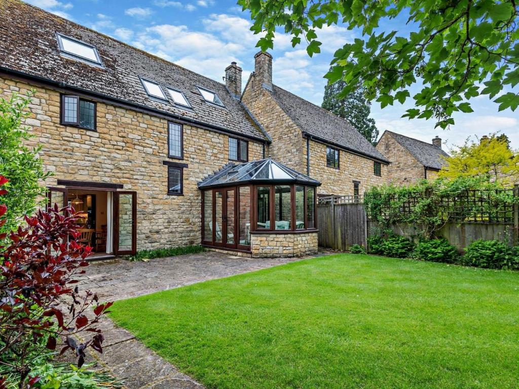 an exterior view of a brick house with a gazebo at 5 Bed in Cheltenham oc-94643 in Lower Slaughter