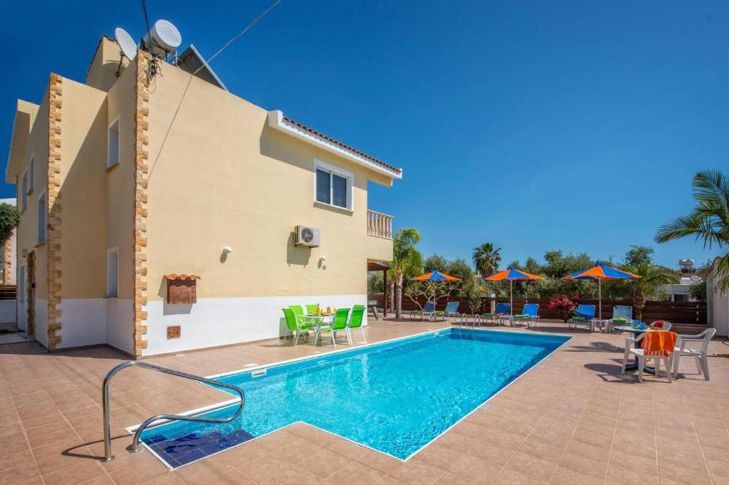 a swimming pool in front of a villa at Villa Semeli by Villa Plus in Peyia