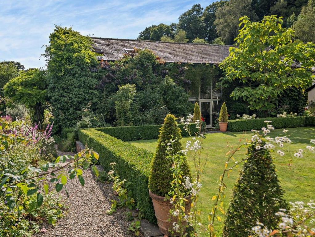 a garden with bushes and trees and a building at 2 Bed in Kington oc-92986 in Lyonshall