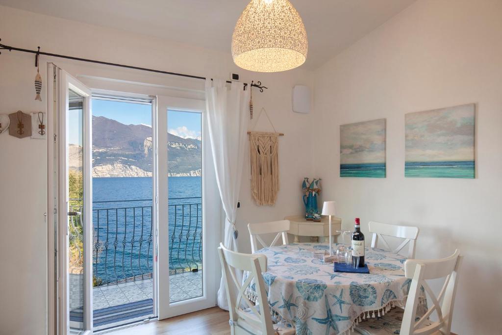 a dining room with a table and a view of the ocean at Il Nido in Brenzone sul Garda