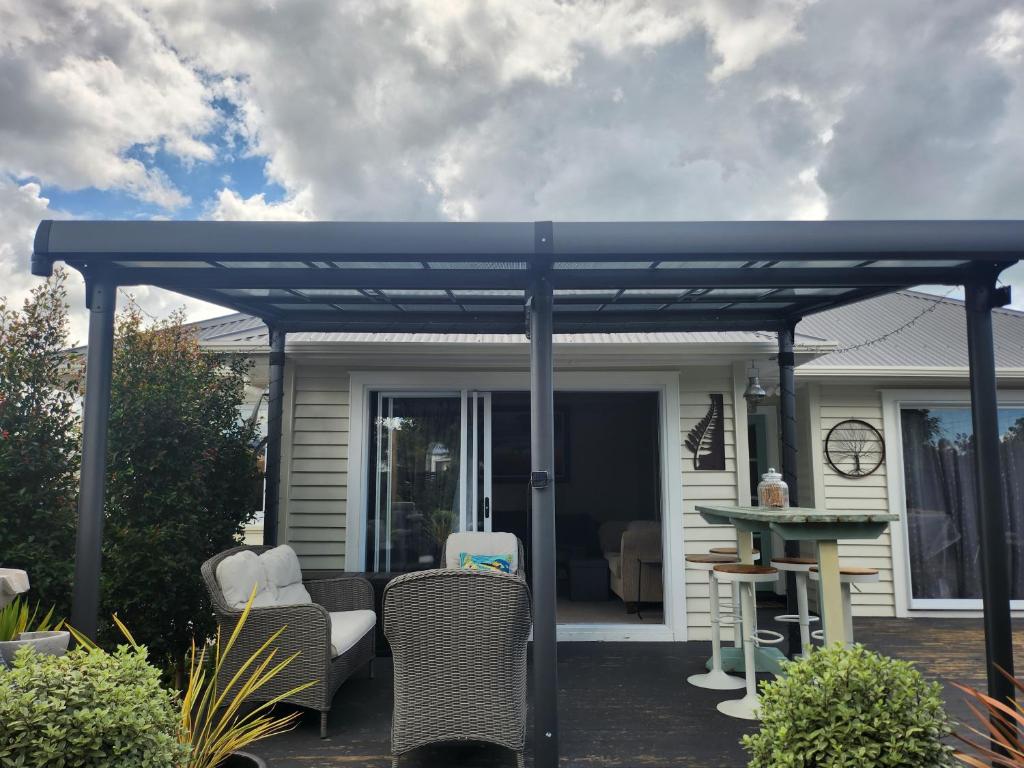 a blue pergola on the patio of a house at Cambridge Oasis in Cambridge