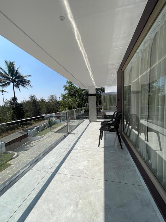 a balcony of a house with a bench on it at Vijay Home Stays in Batheri