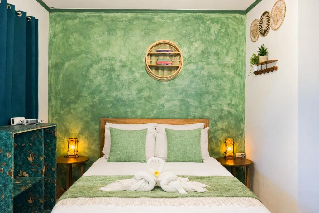 a bedroom with a bed with a towel on it at Lelija Apartment in General Luna