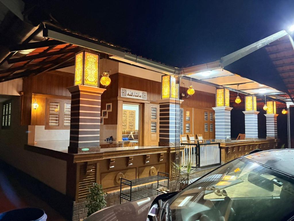 a building with a restaurant with a car parked outside at ARAMAM SERVICE VIlla in Mananthavady