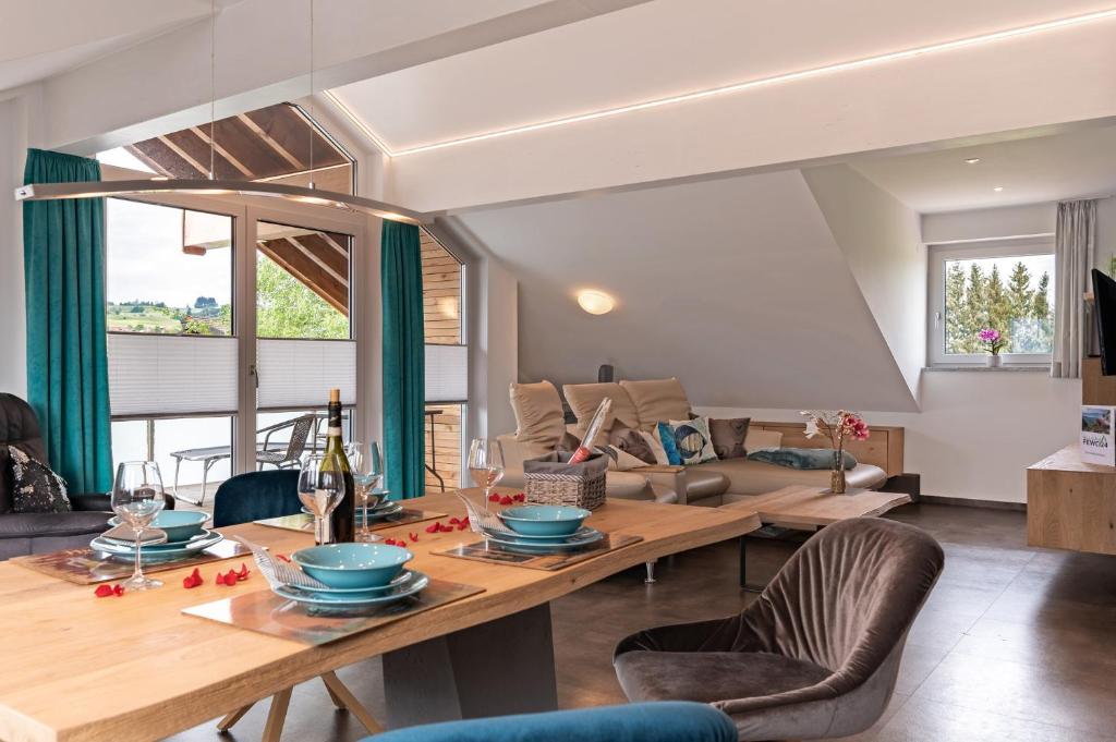 a living room with a table and a couch at Grünten-Chalet in Oy-Mittelberg