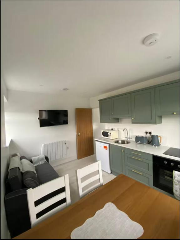 a kitchen and a living room with a couch and a table at Lakeview in Keel