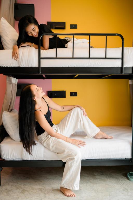 a woman laying on top of a bunk bed at HOST'S EL Fisherman in Nathon Bay
