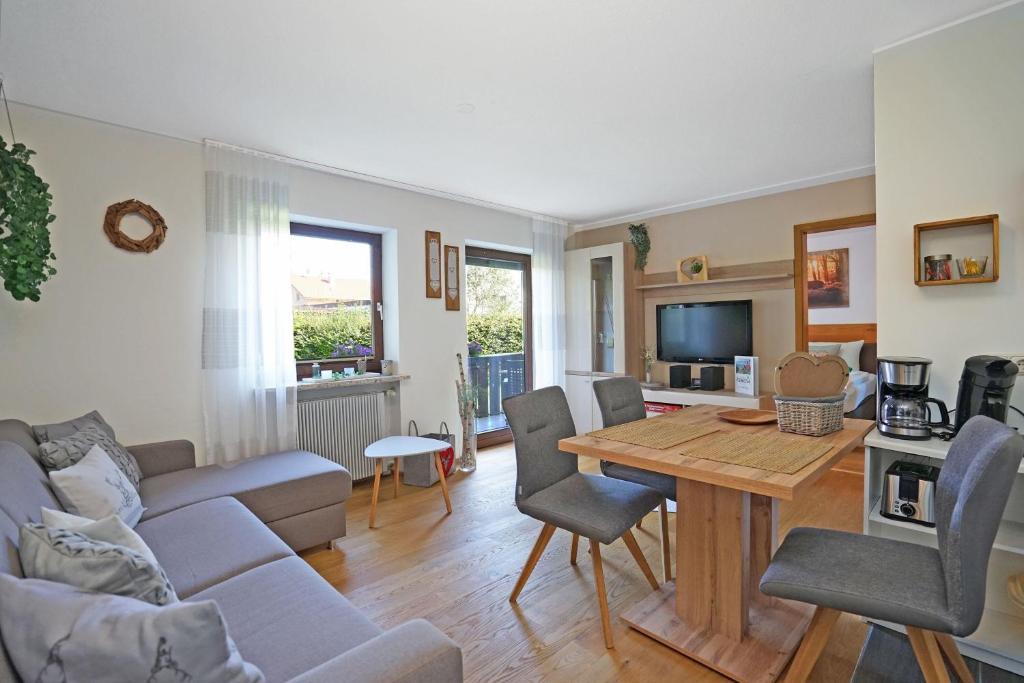 a living room with a couch and a table at Bergliebe in Nesselwang