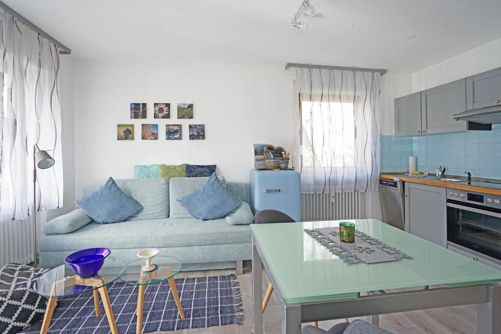 a kitchen and living room with a couch and a table at Am Mühlbach in Nesselwang