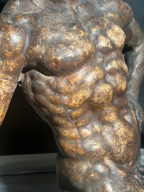 a bronze statue of a man holding a chain at A practical features designed for everyday convenience in Bundaberg