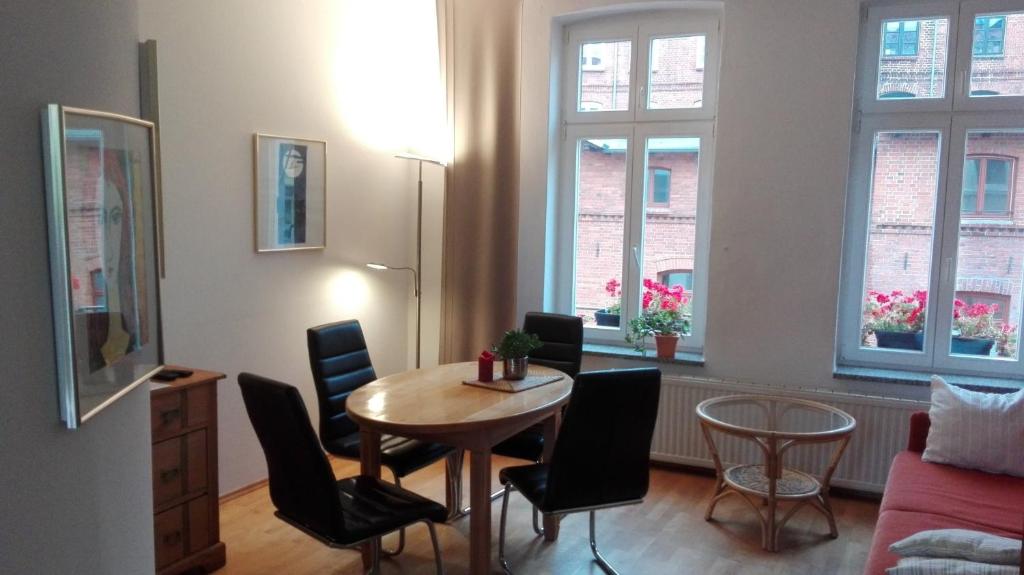 a living room with a table and chairs at Ferienhaus Wismar in Wismar