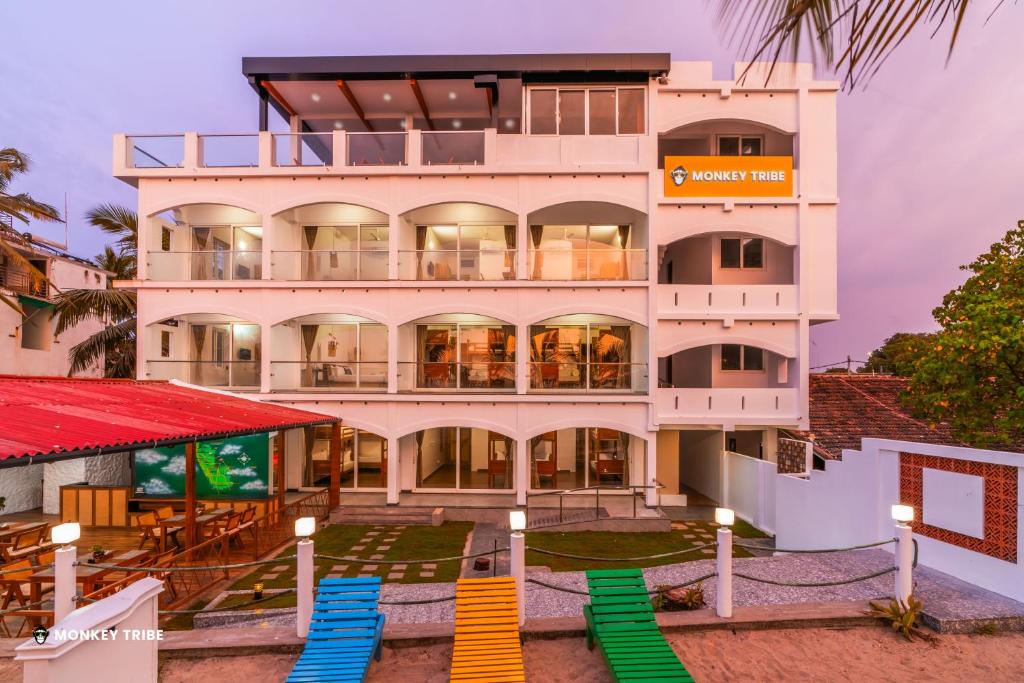 a building with colorful chairs in front of it at Monkey Tribe Alleppey in Alleppey