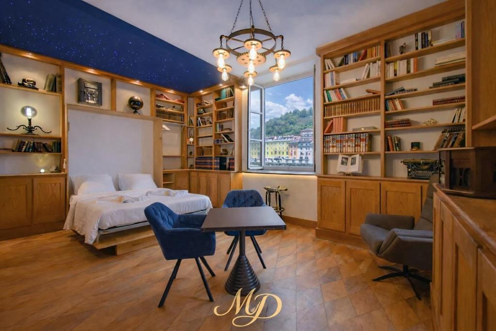 a bedroom with a bed and a table and chairs at MYD - The Jules Verne in Grenoble