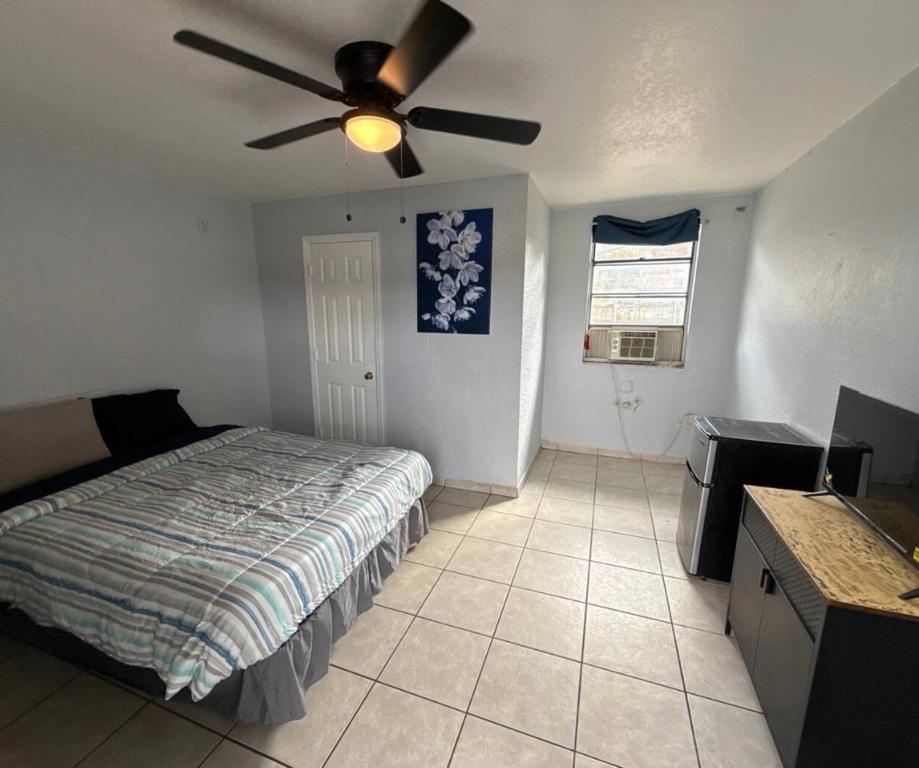 a bedroom with a bed and a ceiling fan at Cozy Cove inn in Saint Cloud