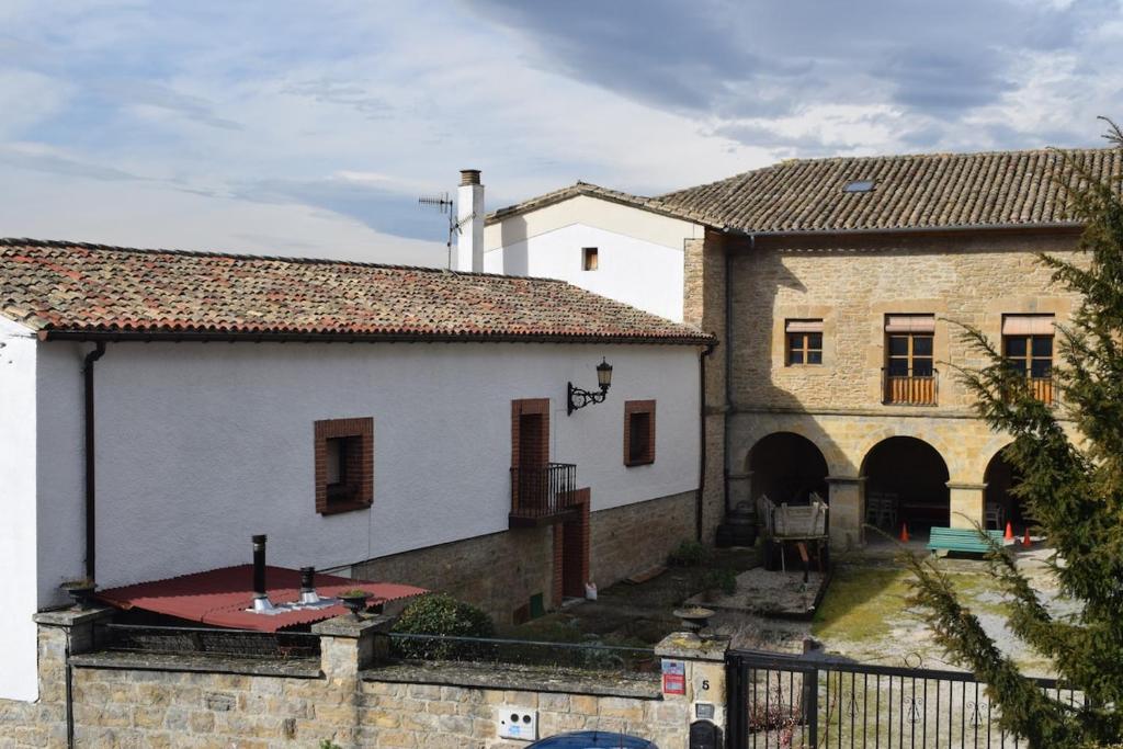 a large white building with a gate in front of it at Ezpeleta Palace in Berriozar