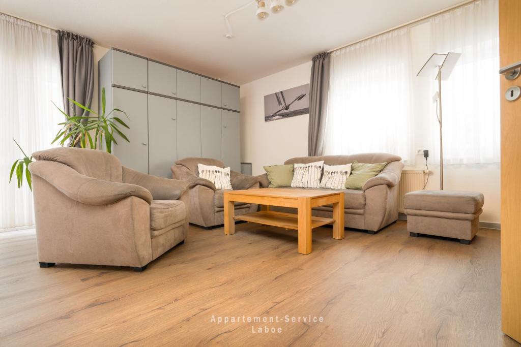 a living room with two couches and a coffee table at Seewind W04 in Laboe