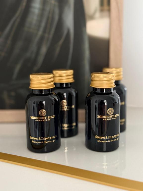 three bottles of ink sitting on a shelf at Apartament SLEEP&GO Ostrowiec Świętokrzyski in Ostrowiec Świętokrzyski