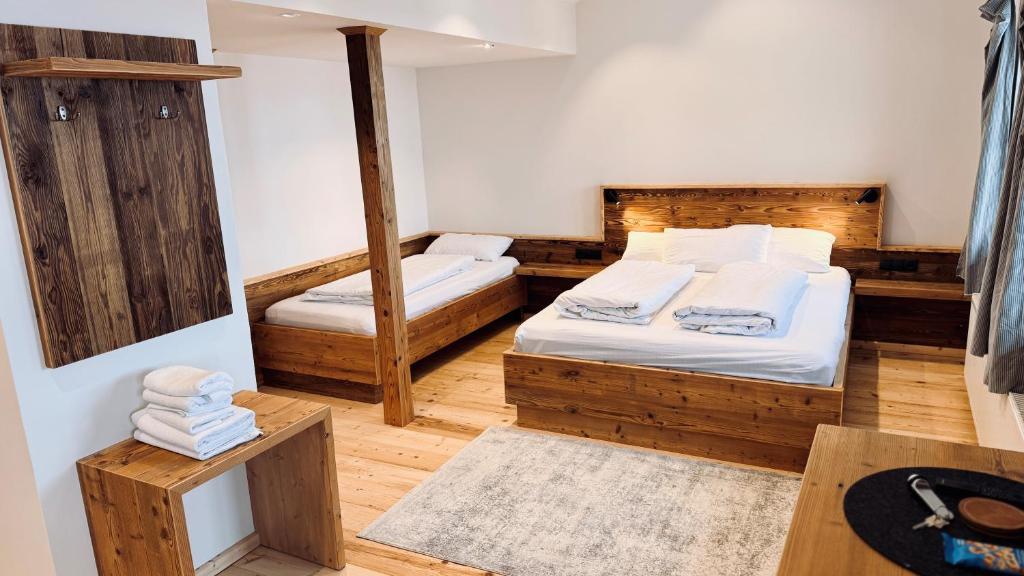 a small room with a bed and a mirror at Vogelbauer Apartments in Egling