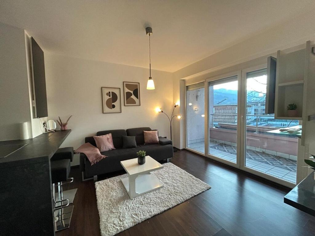 a living room with a couch and a table at Faraway Homes Studio Bruck #11 in Bruck an der Mur